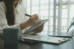 Audit concept,Administrator business man financial inspector and secretary making report calculating balance. Internal Revenue Service checking document. photo
