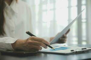 Audit concept,Administrator business man financial inspector and secretary making report calculating balance. Internal Revenue Service checking document. photo