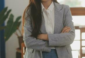 Portrait of Asian young female working on laptop at office photo