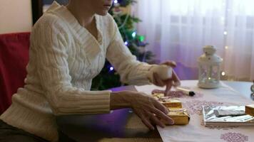 Young lady between 30 and 35 years old prepares Christmas gifts for her relatives video