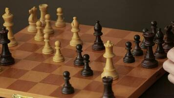 Father and a son are playing chess. Closeup video