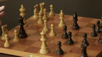 Father and a son are playing chess. Closeup video