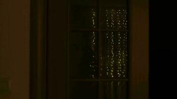 Christmas ornaments and light reflected on the window at night video