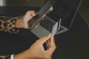 Women holding credit card and using smartphones at home.Online shopping, internet banking, store online, payment, spending money, e-commerce payment at the store, credit card, concept photo