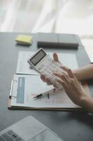 Audit concept,Administrator business man financial inspector and secretary making report calculating balance. Internal Revenue Service checking document. photo