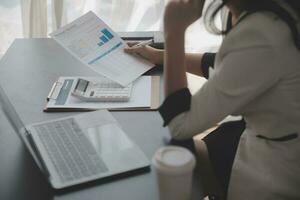 Audit concept,Administrator business man financial inspector and secretary making report calculating balance. Internal Revenue Service checking document. photo
