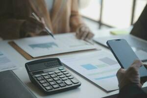 Audit concept,Administrator business man financial inspector and secretary making report calculating balance. Internal Revenue Service checking document. photo