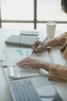 Audit concept,Administrator business man financial inspector and secretary making report calculating balance. Internal Revenue Service checking document. photo
