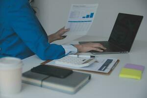 Audit concept,Administrator business man financial inspector and secretary making report calculating balance. Internal Revenue Service checking document. photo