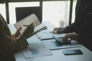 Audit concept,Administrator business man financial inspector and secretary making report calculating balance. Internal Revenue Service checking document. photo