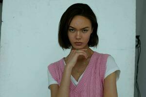 woman in pink vest posing emotions studio fashion photo