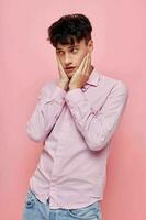 portrait of a young man posing fashion pink shirt modern style isolated background unaltered photo