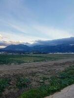 View from the side of the city in front of mountain photo