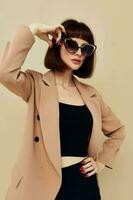 portrait of a woman in sunglasses short haired suit gesturing with hands Lifestyle unaltered photo