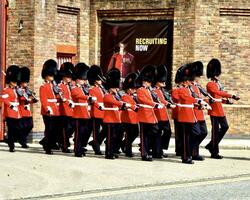 Windsor, England, June, 2017, Queen'sGuard marching towards Windsor Castle photo