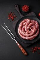 Raw sausages from pork or beef with salt, spices and herbs photo