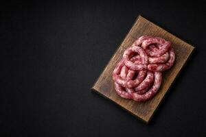 Raw sausages from pork or beef with salt, spices and herbs photo