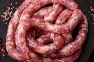 Raw sausages from pork or beef with salt, spices and herbs photo