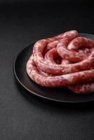 Raw sausages from pork or beef with salt, spices and herbs photo