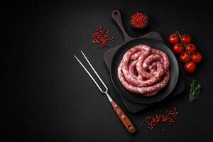 Raw sausages from pork or beef with salt, spices and herbs photo