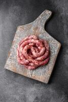 Raw sausages from pork or beef with salt, spices and herbs photo