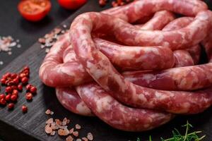 Raw sausages from pork or beef with salt, spices and herbs photo