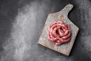 Raw sausages from pork or beef with salt, spices and herbs photo