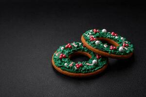 Delicious Christmas gingerbread cookies on a dark textured concrete background photo