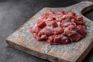 Raw chicken or turkey gizzards with salt, spices and herbs photo