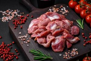Raw chicken or turkey gizzards with salt, spices and herbs photo