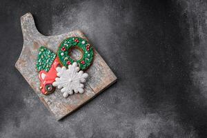 Delicious beautiful Christmas gingerbread cookies on a textured concrete background photo