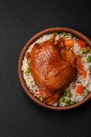 Delicious boiled rice with chicken and vegetables or risotto with salt, spices and herbs photo