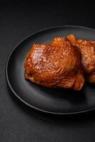 Delicious fried or smoked chicken thighs grilled with spices and herbs photo