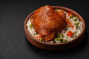 Delicious boiled rice with chicken and vegetables or risotto with salt, spices and herbs photo