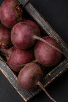 Fresh raw beetroot in the form of tubers on a textured concrete background photo