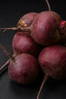 Fresh raw beetroot in the form of tubers on a textured concrete background photo