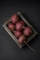 Fresh raw beetroot in the form of tubers on a textured concrete background photo