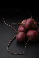 Fresh raw beetroot in the form of tubers on a textured concrete background photo