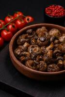 Delicious champignon mushrooms with salt, spices and herbs photo