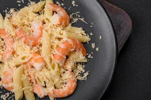 Delicious fresh penna pasta with shrimp, sauce, cheese, salt and spices photo