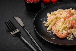 Delicious fresh penna pasta with shrimp, sauce, cheese, salt and spices photo