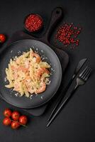 Delicious fresh penna pasta with shrimp, sauce, cheese, salt and spices photo