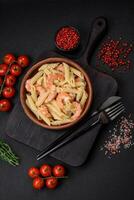 Delicious fresh penna pasta with shrimp, sauce, cheese, salt and spices photo