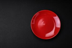 Empty ceramic plate on dark textured concrete background photo