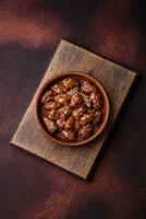 Chicken hearts fried in soy sauce with salt and spices in a plate photo