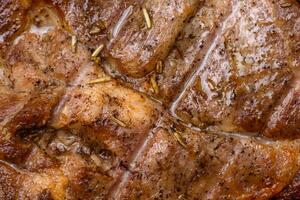 Delicious juicy pork or beef steak grilled with salt, spices and herbs photo