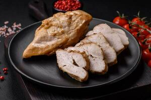 Delicious fresh grilled chicken fillet with salt, spices and herbs on a ceramic plate photo