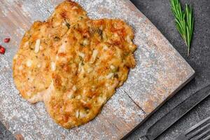 Delicious fried chicken breast in batter with mustard, salt, spices and cheese photo