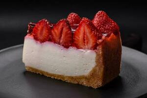 Delicious fresh cheesecake with strawberries, syrup and mascarpone cheese photo