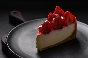 Delicious fresh cheesecake with strawberries, syrup and mascarpone cheese photo